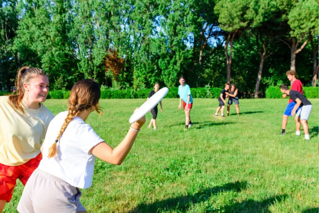 teens outdoors playing with a frisbee