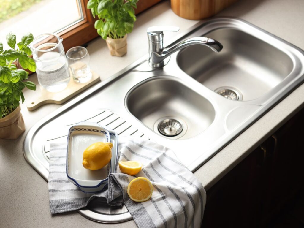 a sink with a lemon next to it