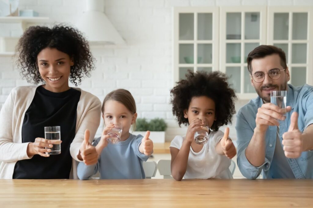 a family drinking glasses of water