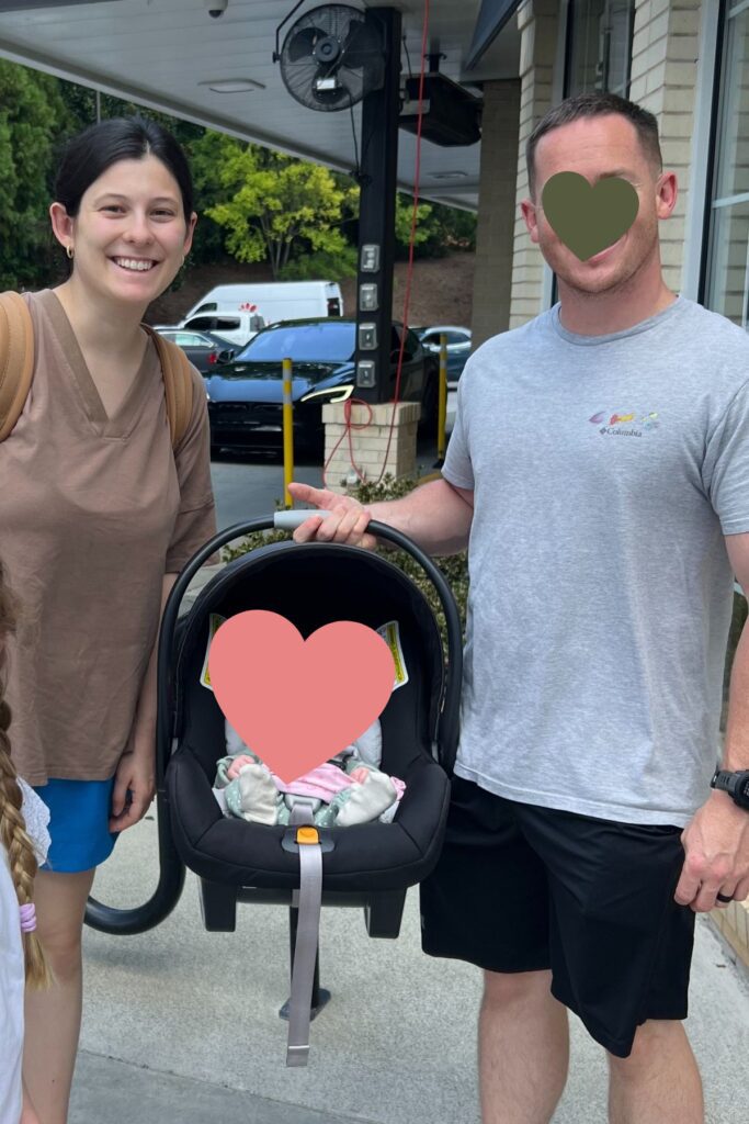 two parents holding their baby